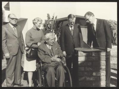 PHOTOGRAPH: MR ABRAHAMS IN WHEELCHAIR AND FRIENDS
