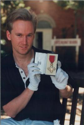 PHOTOGRAPH: STUDENT HANDLING MUSEUM OBJECTS