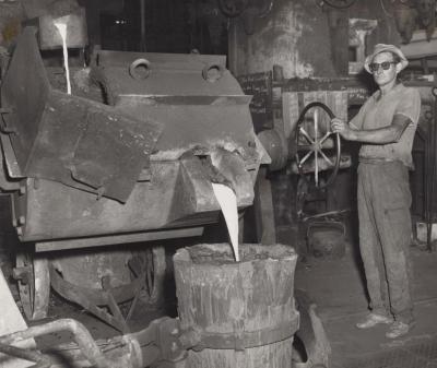 PHOTOGRAPH: METTERS' WORKER POURING METAL