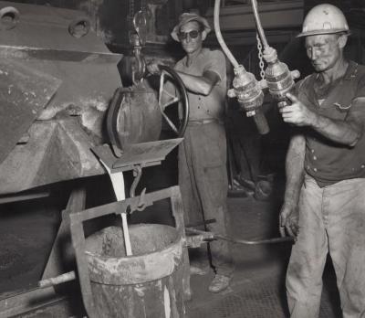 PHOTOGRAPH: METTERS' WORKERS WEIGHING MOLTEN METAL
