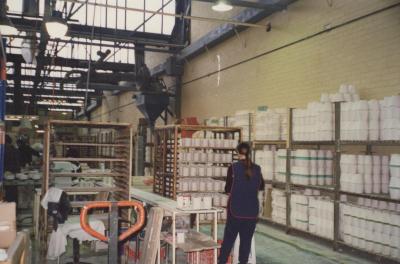 PHOTOGRAPH: WORKER AND SHELVES OF MOULDS AT AUSTRALIAN FINE CHINA FACTORY