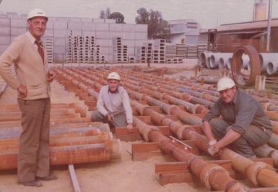 PHOTOGRAPH: HUMES WORKERS WITH HUMES PIPES