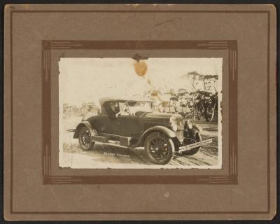 PHOTOGRAPH: PADDY BAKER IN AN OLD CAR