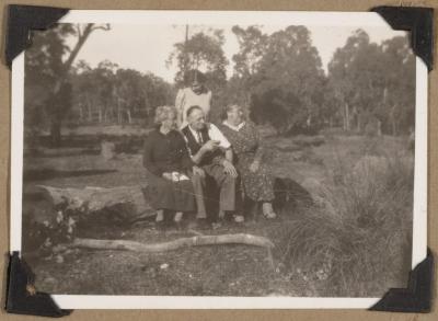 PHOTOGRAPH (DIGITAL): GROUP PHOTO SITTING ON A LOG, FROM CONGDON FAMILY ALBUM