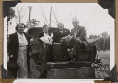 PHOTOGRAPH (DIGITAL): A GROUP OF PEOPLE STANDING BESIDE AND SITTING IN THE BACK OF A VEHICLE , FROM CONGDON FAMILY ALBUM