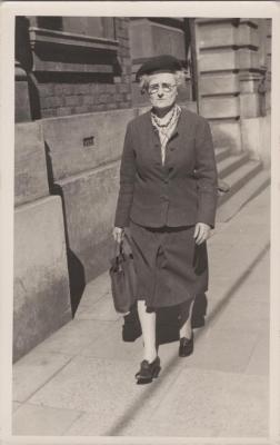 PHOTOGRAPH: WOMAN WALKING IN THE STREET, CIRCA 1940