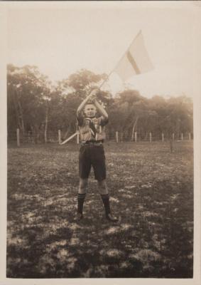 PHOTOGRAPH: SCOUT WITH FLAG, SCOUTS BUSH CAMP