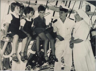 PHOTOGRAPH (COPY): CHILDREN FROM ST JOSEPH'S ORPHANAGE WITH SAILORS AND NUN, HMS EAGLE