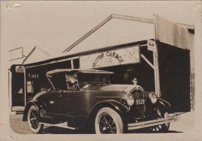 PHOTOGRAPH: PADDY BAKER'S MOTOR VEHICLE PARKED OUTSIDE A GARAGE