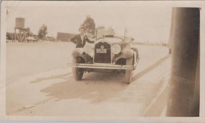 PHOTOGRAPH: PADDY BAKER WITH MOTOR VEHICLE