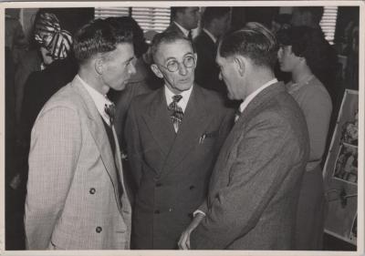 PHOTOGRAPH: PADDY BAKER IN CONVERSATION WITH TWO MEN