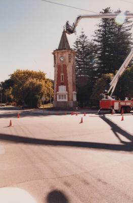PHOTOGRAPH (DIGITAL): FALLEN SOLDIERS MEMORAL CLOCK TOWER, CLEANING OF THE CLOCK, 1988