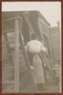 PHOTOGRAPH (DIGITAL): WOMAN STANDING BY A LADDER, FROM CONGDON FAMILY ALBUM