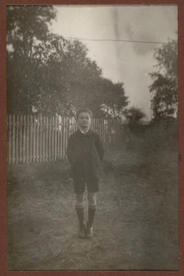 PHOTOGRAPH (DIGITAL): VIC TRENBERTH STANDING IN A YARD, FROM CONGDON FAMILY ALBUM