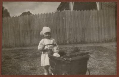 PHOTOGRAPH (DIGITAL): THELMA CONGDON WITH A DOLL IN A PRAM, FROM CONGDON FAMILY ALBUM