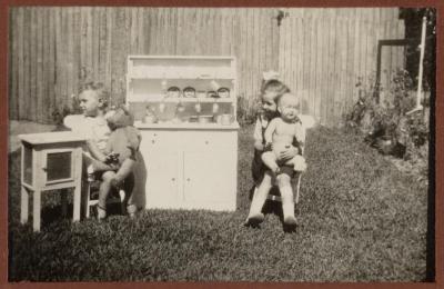 PHOTOGRAPH (DIGITAL): NORMA SUMMERS AND THELMA CONGDON, PLAYING IN A GARDEN, 75 GLOSTER STREET, FROM CONGDON FAMILY ALBUM