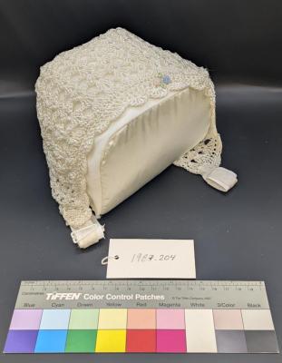 BONNET: BABY'S BONNET, CROCHET, WHITE SILK, EMBROIDERED ROSES (MATCHING JACKET 1987.203)